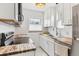 Modern kitchen featuring white cabinets, butcher block counters, and stainless steel appliances at 1220 Magnolia St, Denver, CO 80220