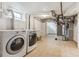 Functional laundry room with washer, dryer, sink, and a utility area with tiled flooring at 1220 Magnolia St, Denver, CO 80220