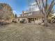Expansive backyard featuring mature trees, lawn, and covered patio at 6141 W Evans Pl, Lakewood, CO 80227