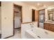 Bathroom featuring soaking tub with a shower, and vanity with dual sinks at 6141 W Evans Pl, Lakewood, CO 80227