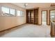 Spacious bedroom with built-in shelves and carpeting at 6141 W Evans Pl, Lakewood, CO 80227