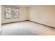 Spacious bedroom with neutral carpeting and large windows at 6141 W Evans Pl, Lakewood, CO 80227