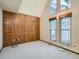 Empty bedroom featuring large windows and paneling at 6141 W Evans Pl, Lakewood, CO 80227