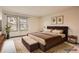 Comfortable bedroom with a plush bed, bench, and framed art at 6141 W Evans Pl, Lakewood, CO 80227