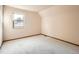 Upstairs bedroom with window and neutral walls at 6141 W Evans Pl, Lakewood, CO 80227