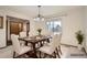 Dining room with seating for six and light from sliding glass door at 6141 W Evans Pl, Lakewood, CO 80227