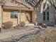 Brick front entrance with a wooden door and landscaping at 6141 W Evans Pl, Lakewood, CO 80227