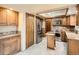 Kitchen featuring wood cabinets, granite counters, and stainless appliances at 6141 W Evans Pl, Lakewood, CO 80227