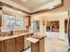 Kitchen featuring wood cabinets, granite counters, and stainless appliances at 6141 W Evans Pl, Lakewood, CO 80227