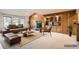 Staged living room with a wooden fireplace and built-in bar area at 6141 W Evans Pl, Lakewood, CO 80227