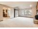 Spacious living room with a fireplace and access to the backyard at 6141 W Evans Pl, Lakewood, CO 80227
