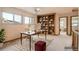 Bright office featuring built in bookshelves, desk, chair, and plush carpet at 6141 W Evans Pl, Lakewood, CO 80227