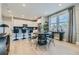 Modern kitchen with stainless steel appliances and adjacent dining area with large windows at 6864 Bryant Ct, Denver, CO 80221