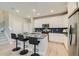 Bright kitchen with a central island, bar stool seating, and modern appliances at 6864 Bryant Ct, Denver, CO 80221