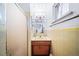Small bathroom with yellow tile and single sink vanity at 2095 Newland St, Edgewater, CO 80214