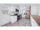 Bright kitchen featuring white cabinetry, stainless steel appliances, and butcher block countertops at 2095 Newland St, Edgewater, CO 80214