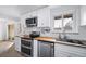 Modern kitchen with white subway tile backsplash, butcher block countertops, and stainless steel appliances at 2095 Newland St, Edgewater, CO 80214