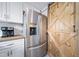 Bright kitchen with stainless steel refrigerator and a rustic wooden barn door at 2095 Newland St, Edgewater, CO 80214