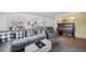 Living room with sectional sofa, arm chair, and antique piano at 2095 Newland St, Edgewater, CO 80214
