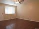 Cozy living room with hardwood floors, neutral paint, bright natural light and a ceiling fan at 6741 Leyden St, Commerce City, CO 80022