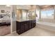 Ensuite bathroom with double vanity and a soaking tub at 3140 S Nepal Way, Aurora, CO 80013