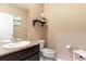 Main floor bathroom with granite vanity and toilet at 3140 S Nepal Way, Aurora, CO 80013