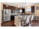 Eat-in kitchen with granite island and dark wood cabinetry at 3140 S Nepal Way, Aurora, CO 80013