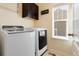 Bright laundry room with washer, dryer, and cabinets at 3140 S Nepal Way, Aurora, CO 80013