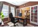 Well-lit office space with a desk, comfortable chair, french doors and view into an adjacent room at 3140 S Nepal Way, Aurora, CO 80013