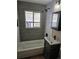 Updated bathroom with subway tile, a bathtub, and a modern vanity at 1690 S Umatilla St, Denver, CO 80223