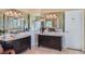 A spacious bathroom featuring dual vanities, with mirrors, offering ample counter space and storage at 24860 N Mountain Park Dr, Evergreen, CO 80439