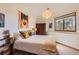 Cozy bedroom with charming accents and a large window offering views of the surrounding landscape at 24860 N Mountain Park Dr, Evergreen, CO 80439
