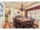 Charming dining room boasts a large window, and classic chandelier at 24860 N Mountain Park Dr, Evergreen, CO 80439