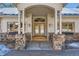 Elegant front entrance with detailed glass doors, stone accents, and sidelight windows, providing natural light and curb appeal at 24860 N Mountain Park Dr, Evergreen, CO 80439