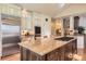 Bright kitchen boasts large island, granite countertops, stainless steel appliances, and eat in dining at 24860 N Mountain Park Dr, Evergreen, CO 80439