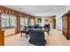 Bright living room features comfortable seating, large windows, and plush carpeting at 24860 N Mountain Park Dr, Evergreen, CO 80439