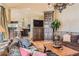 Inviting living room featuring hardwood floors, a cozy sofa, and seamless flow to the kitchen at 24860 N Mountain Park Dr, Evergreen, CO 80439