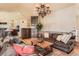 Comfortable living room with hardwood floors, plush sofas, and a seamless transition to the open kitchen area, great for entertaining at 24860 N Mountain Park Dr, Evergreen, CO 80439