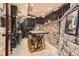 Impressive wine cellar features a brick accent wall and extensive storage for the avid wine collector at 24860 N Mountain Park Dr, Evergreen, CO 80439