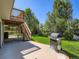 Spacious backyard with patio area, lush lawn, grill and deck at 3859 Rawhide Cir, Castle Rock, CO 80104