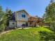 Beautiful backyard featuring a lush green lawn, patio, barbecue grill, storage shed, and a wooden deck with stairs at 3859 Rawhide Cir, Castle Rock, CO 80104