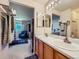 Bright primary bathroom with double sinks, wood cabinets, and neutral decor at 3859 Rawhide Cir, Castle Rock, CO 80104