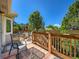 Outdoor deck with nice patio furniture and seasonal plants in containers on a sunny day with blue skies at 3859 Rawhide Cir, Castle Rock, CO 80104