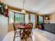 Cozy dining area with a round table and bay window, seamlessly connected to the living space at 3859 Rawhide Cir, Castle Rock, CO 80104