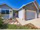 Charming single Gathering home showcasing a brick facade and a 2-car garage with flower bed at 3859 Rawhide Cir, Castle Rock, CO 80104