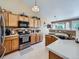 Well-lit kitchen showcasing wood cabinets, stainless steel appliances, and ample counter space at 3859 Rawhide Cir, Castle Rock, CO 80104