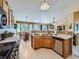 Inviting kitchen featuring tile floors, wood cabinets, and an adjacent breakfast nook with abundant natural light at 3859 Rawhide Cir, Castle Rock, CO 80104