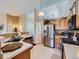 Functional kitchen design, featuring a stainless steel refrigerator and a view into the connected rooms at 3859 Rawhide Cir, Castle Rock, CO 80104