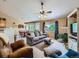 Comfortable living room showcasing a fireplace, neutral decor, and a view into the dining area at 3859 Rawhide Cir, Castle Rock, CO 80104