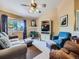 Comfortable living room with a fireplace, large window, and plush seating, perfect for relaxation at 3859 Rawhide Cir, Castle Rock, CO 80104